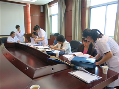 考核组认真查看患者病历及医保流程制度.JPG